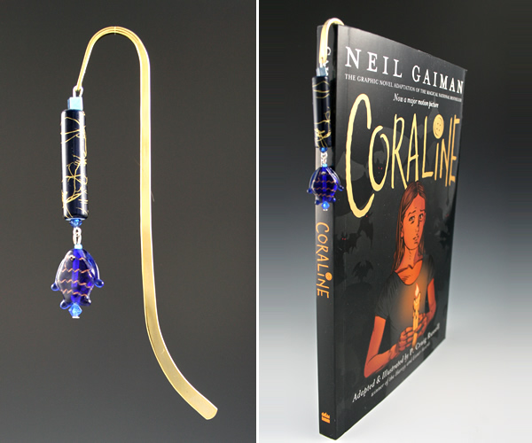 Gold-tone bookmark #16, blue and gold, with blue fish drop, book shot
